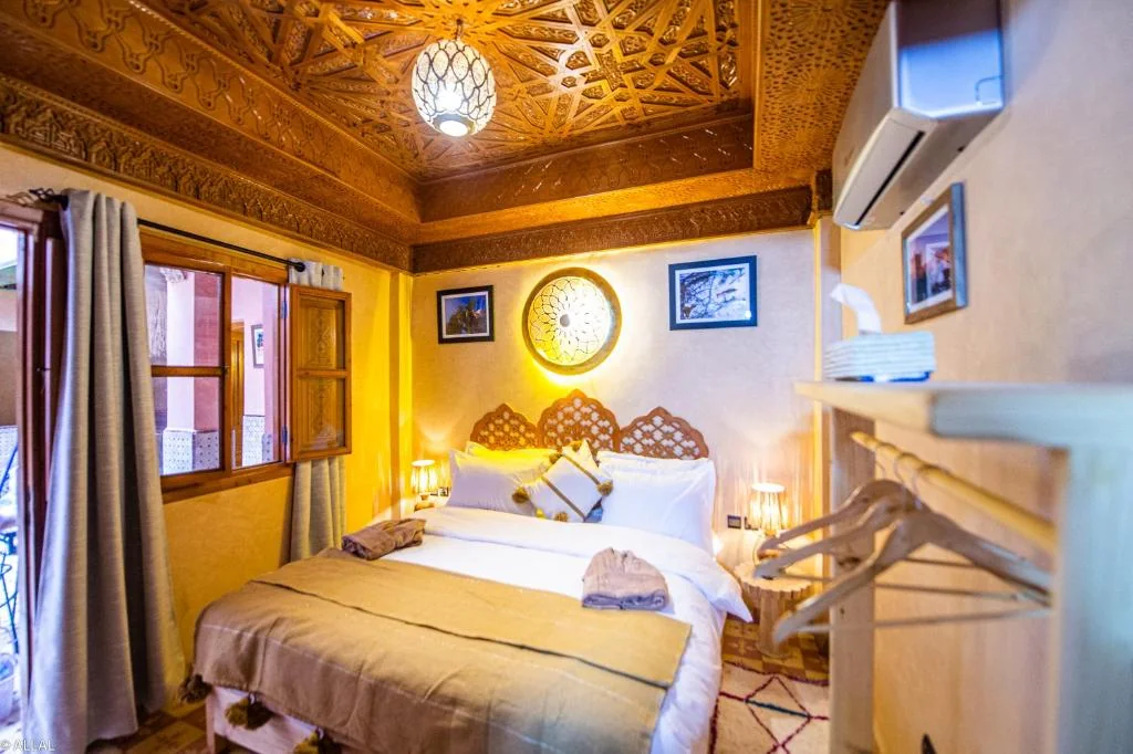 Deluxe double room with carved Moroccan ceiling at Riad Almonds Marrakech